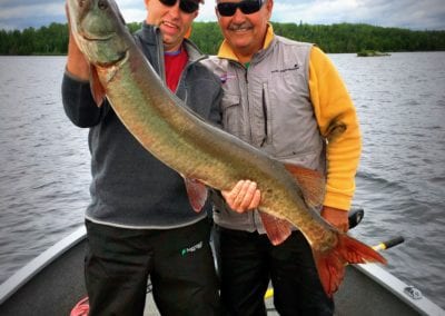 Guide and client with giant muskie on Ontario fishing trip