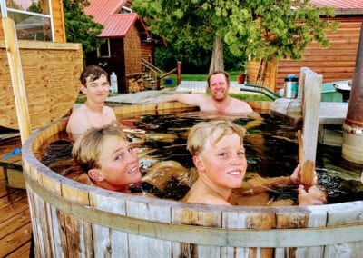 Family relaxing in hot tub in Ontario during fishing trip