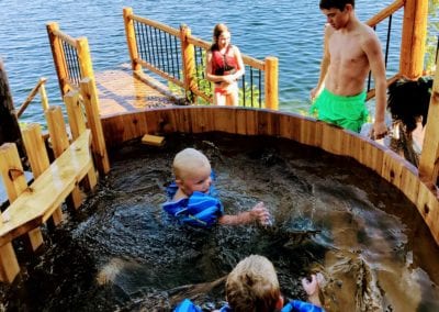 Family relaxing in hot tub and swimming in Ontario during fishing trip