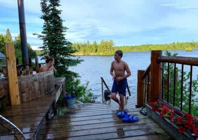 Swimming in cool clear Manitou Lake off main camp dock near hot tub