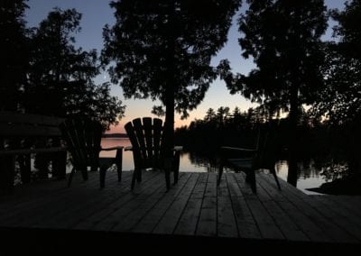 Sunset at dusk at deck overlooking lake Manitou from the Point Cabin