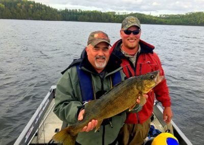 Happy angler and guide Kris with huge walleye at the Manitou