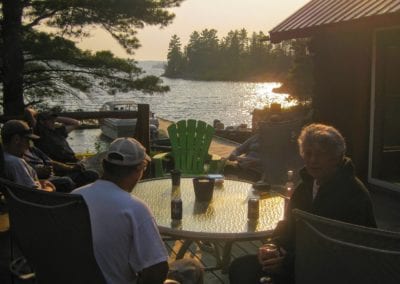 Anglers telling tales on the main deck at sunset after fishing Lower Manitou