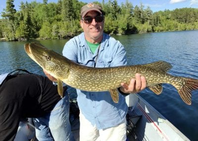 Angler with northern pike in Canada