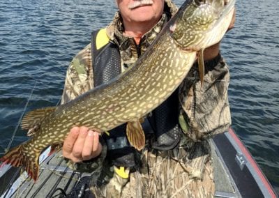 Angler with pike caught at Manitou Weather Station