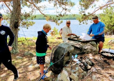 Guides preparing shore lunch in Canada during fishing outing