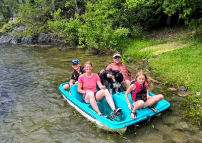 Family taking trip on paddleboat at main lodge camp area on the Manitou