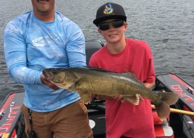 Tanner with Guide Kris and a nice walleye caught on the Manitou