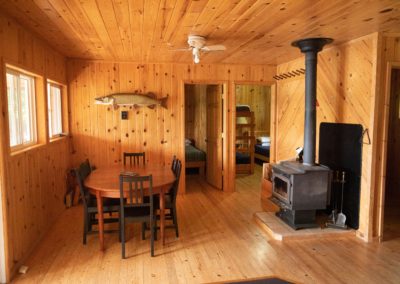 Inside Bay Cabin with fireplace and dining table