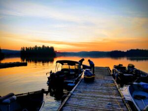 Fishermen loading boats at sunrise on Barker Bay dock at Manitou Weather Station, Lower Manitou Lake